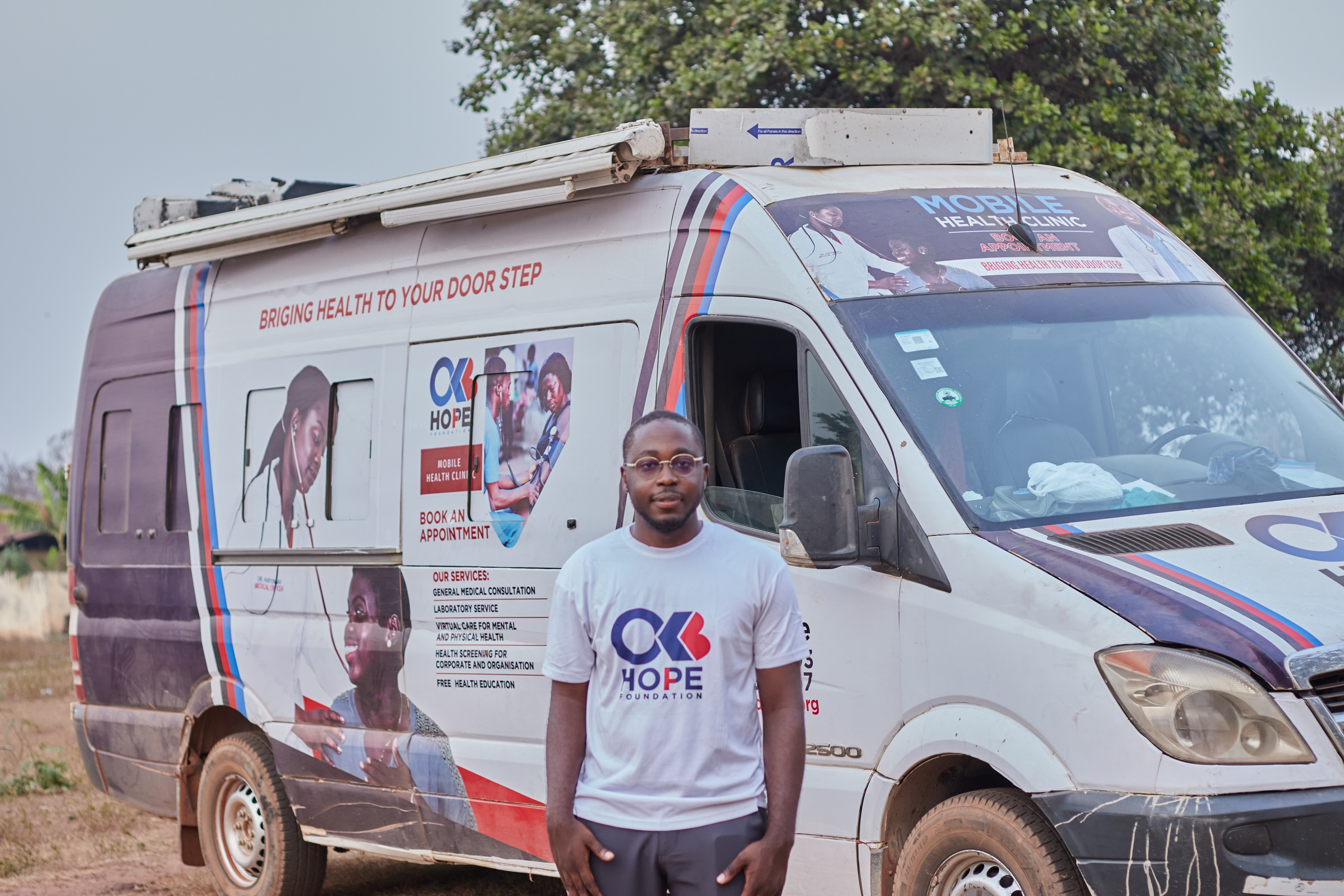 Osei Boateng, Founder of OKB Hope Foundation, in front of the mobile clinic at the Abofour community. Photo: OKB Hope Foundation